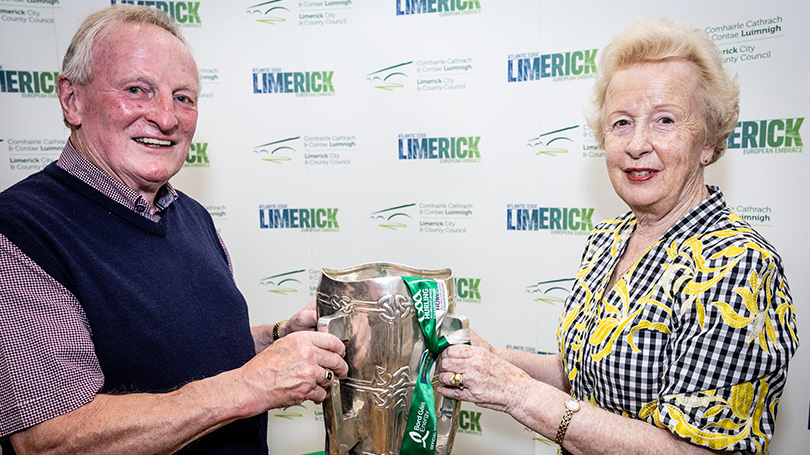 Man and woman holding Liam McCarthy Cup in front of pop-up banners. Pic Keith Wiseman