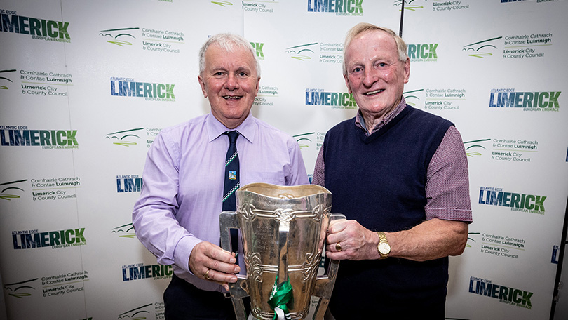 Two man holding the Liam McCarthy Cup in front of pop up banners. Pic Keith Wiseman