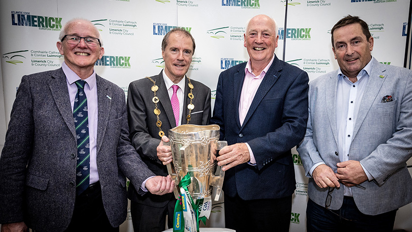 Four men holding the Liam McCarthy Cup in front of pop up banners. Pic Keith Wiseman