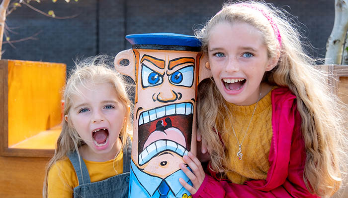 Two girls at a colourful bollard painted with street art in Limerick. Photo: Paul Corey