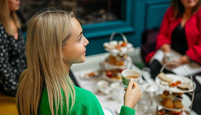 Woman drinking a cup of tea while enjoying an afternoon tea in Adare Co. Limerick