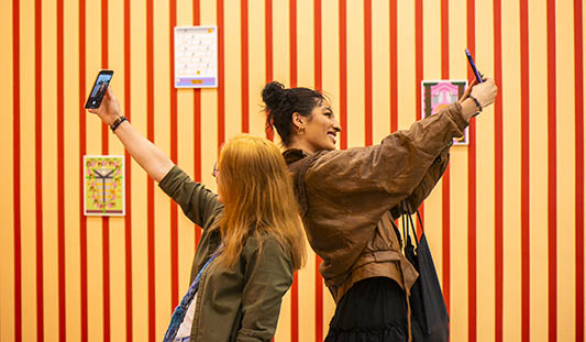 Two women taking a selfie photo at an exhibition at Limerick City Gallery of Art